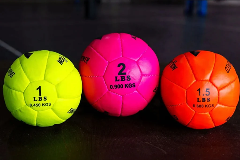 Three weighted Pro Spike Flow trainers on the gym floor.